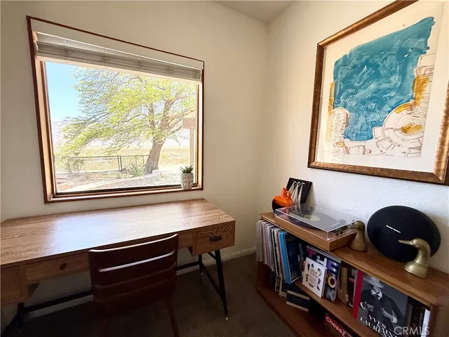 a reading room with wooden floor and window