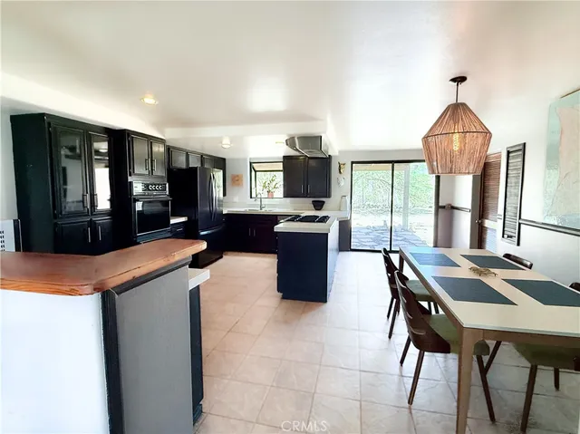 a kitchen with stainless steel appliances granite countertop a sink a stove and a refrigerator