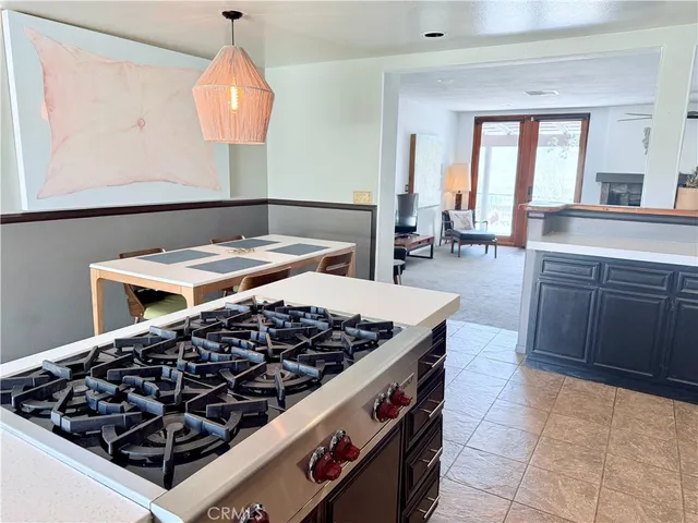 a kitchen with a stove a sink and a wooden cabinets