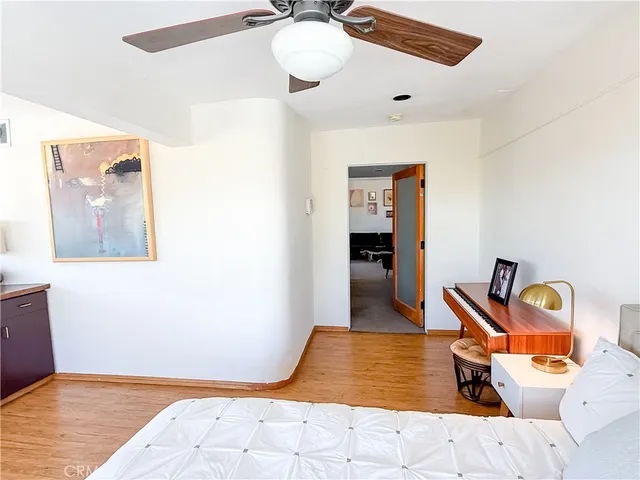 a bedroom with a bed and wooden floor