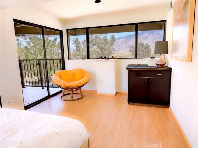 a living room with a large window and a table