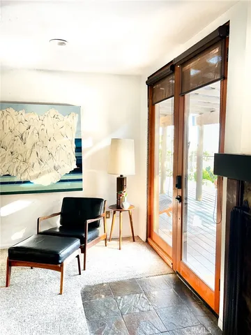 a living room with furniture and a floor to ceiling window
