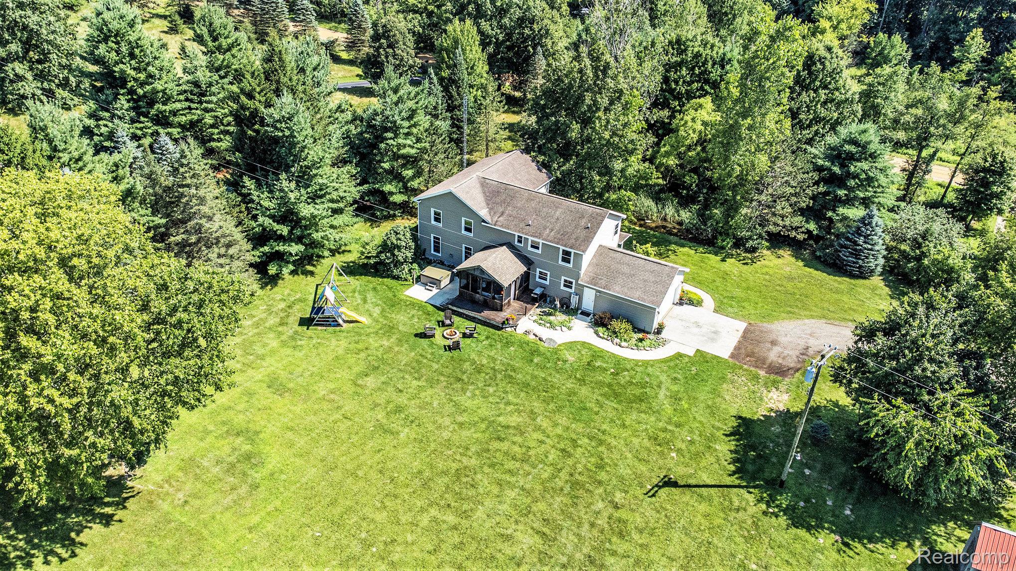 5083 Curtis Road Attica, MI 48412 - Photo 40 of 44 View from above of property featuring a tree filled landscape