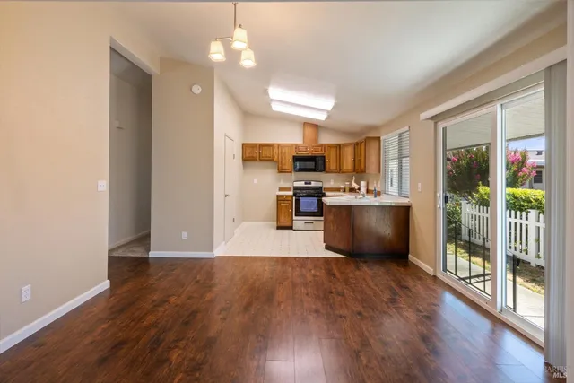 a view of kitchen with microwave and wooden floor