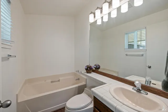 a bathroom with a sink a toilet and bathtub