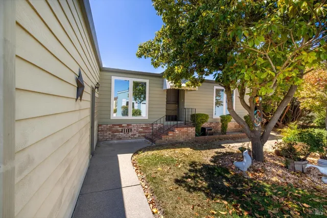 a view of a house with a chairs in the patio