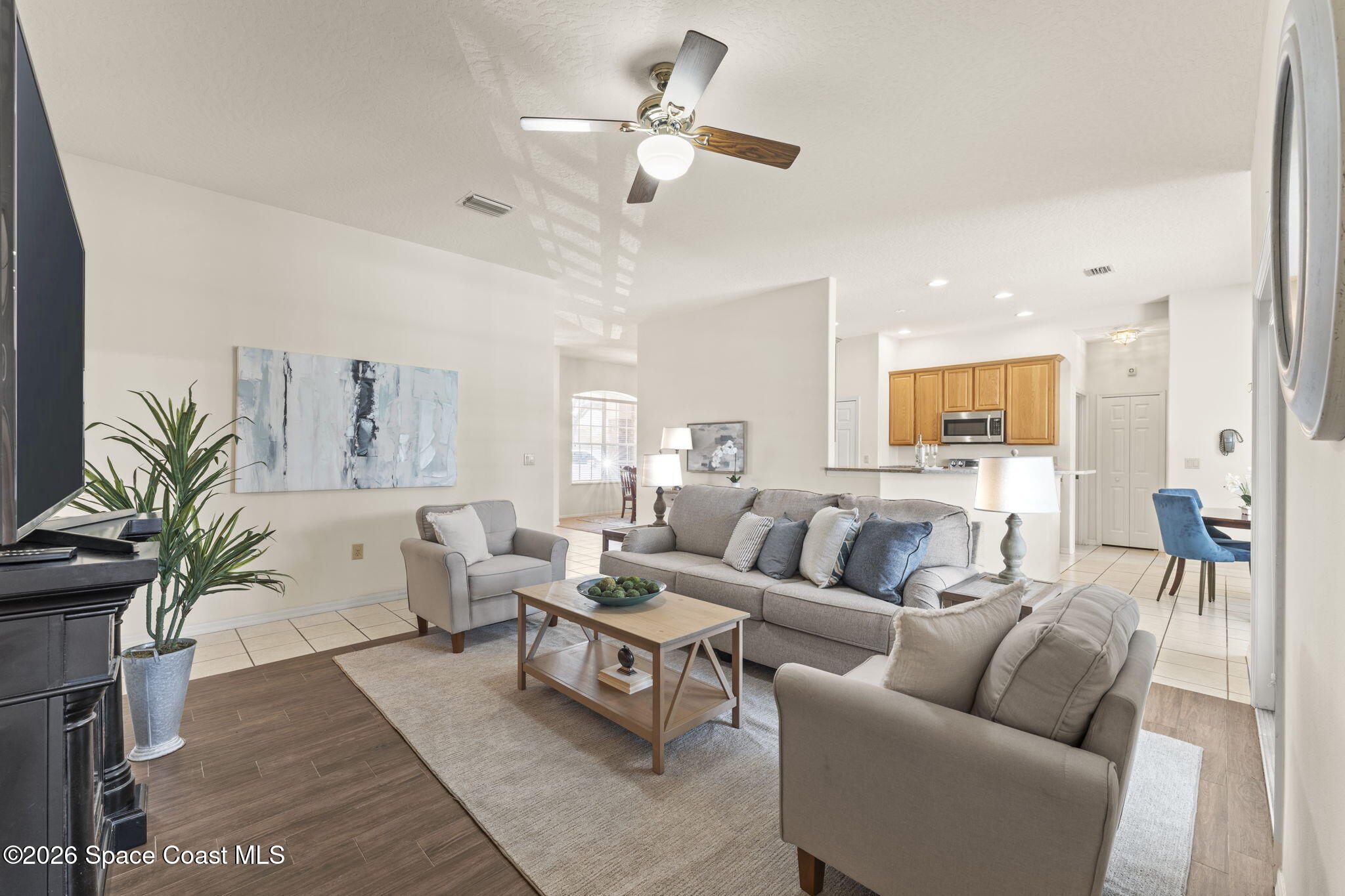1123 Spring Oak Drive Melbourne, FL 32901 - Photo 30 of 67 a living room with furniture kitchen view and a chandelier