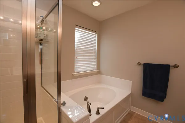 a bathroom with a tub and a shower