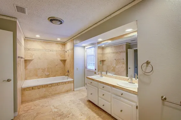 a bathroom with a double vanity sink toilet mirror and shower