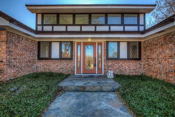 a front view of a house with a yard outdoor seating and garden