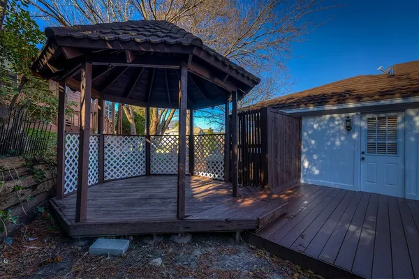 a view of a wooden deck with a backyard