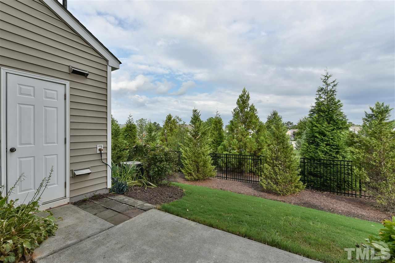 8133 Rhiannon Road Raleigh, NC 27613 - Photo 12 of 13 Private patio backing up to a wooded area. Perfect for entertaining or enjoying the quiet at the end of the day! Storage area for your extras too