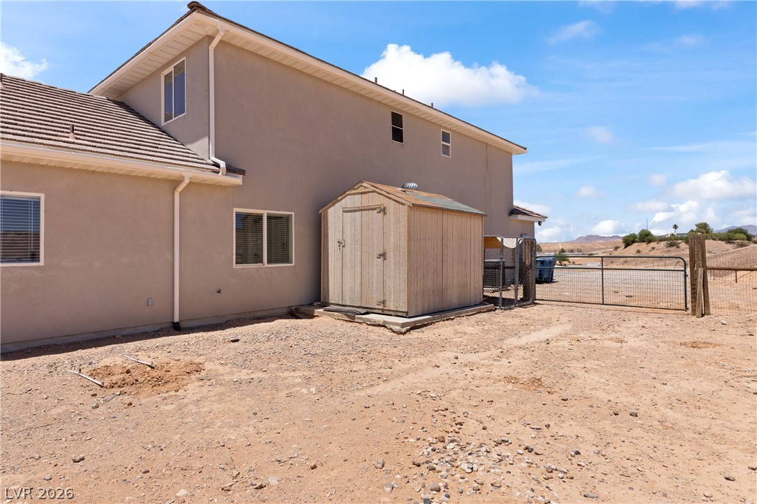 575 Gann Avenue Logandale, NV 89021 - Photo 55 of 75 A spacious yard with a practical shed, offering additional storage and utility to the property.