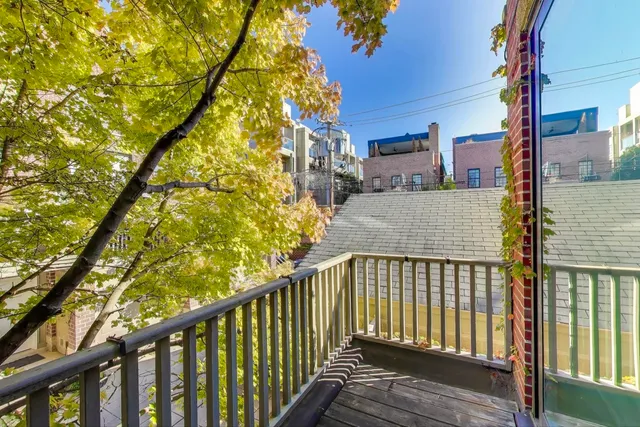 a view of a balcony with wooden floor