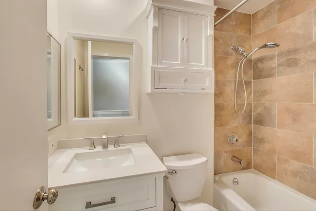 a view of a hallway with wooden floor and stairs