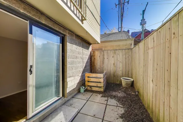 a view of a balcony with wooden floor and iron stairs