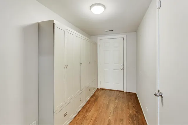 a view of a hallway with wooden floor