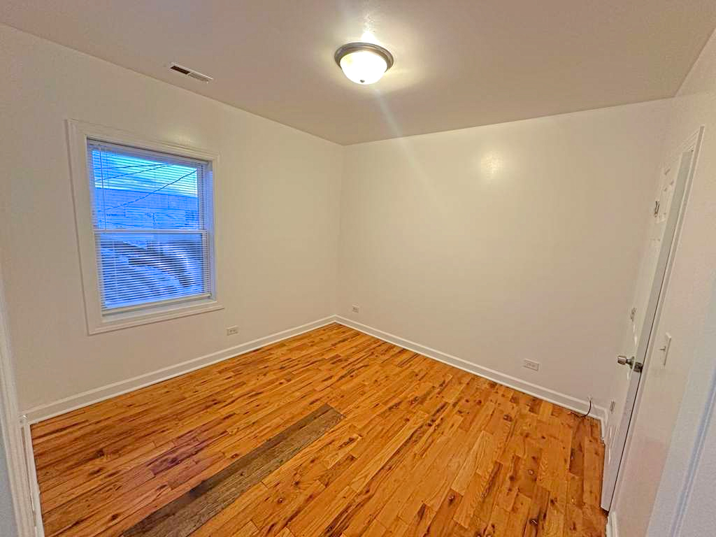 5145 West Ferdinand Street, Unit 2 Chicago, IL 60644 - Photo 11 of 13 a view of empty room with wooden floor