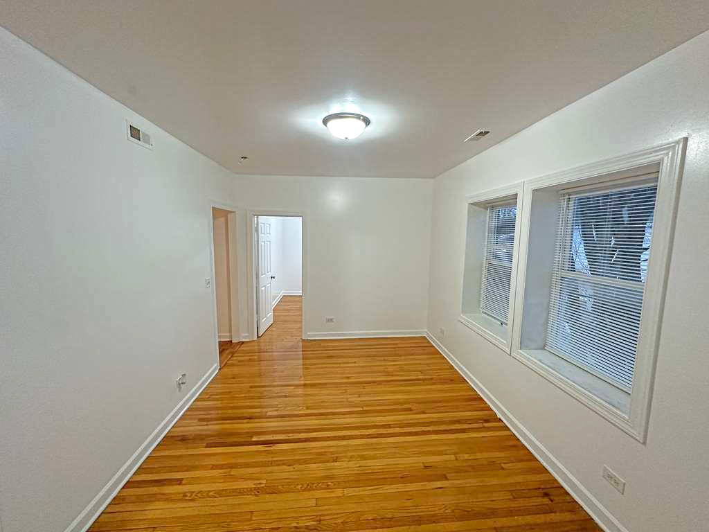 5145 West Ferdinand Street, Unit 2 Chicago, IL 60644 - Photo 3 of 13 a view of a big room with wooden floor and windows