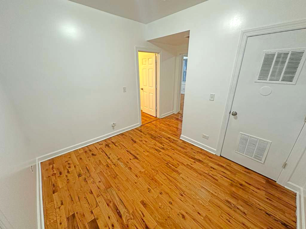 5145 West Ferdinand Street, Unit 2 Chicago, IL 60644 - Photo 4 of 13 a view of empty room with wooden floor
