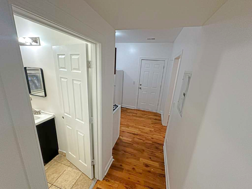 5145 West Ferdinand Street, Unit 2 Chicago, IL 60644 - Photo 7 of 13 a view of a hallway with wooden floor and staircase