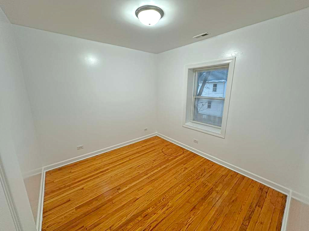 5145 West Ferdinand Street, Unit 2 Chicago, IL 60644 - Photo 9 of 13 a view of empty room with wooden floor