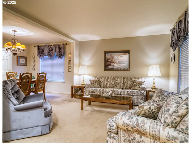 a living room with furniture and painting on the wall