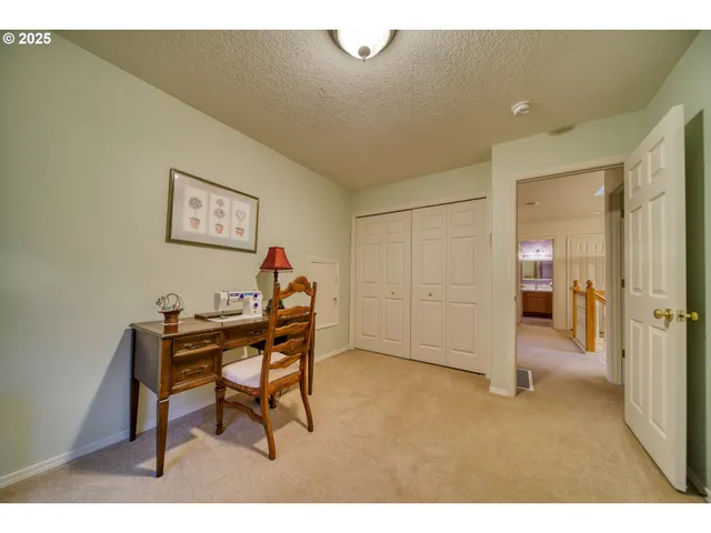 a spacious bedroom with a bed and a dresser