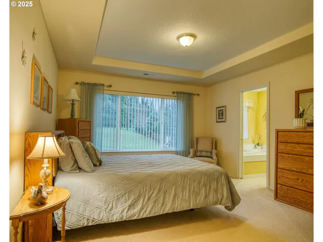 a bedroom with a bed and a chair