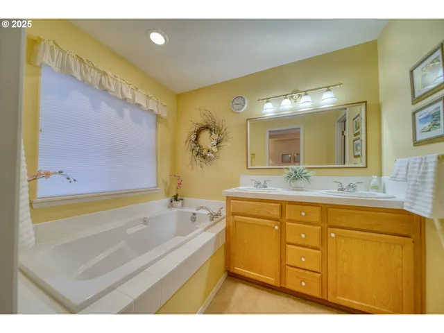 a bathroom with a granite countertop sink mirror vanity and toilet