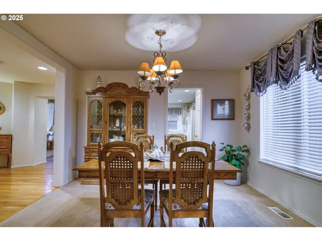 a view of a dining room with furniture and chandelier