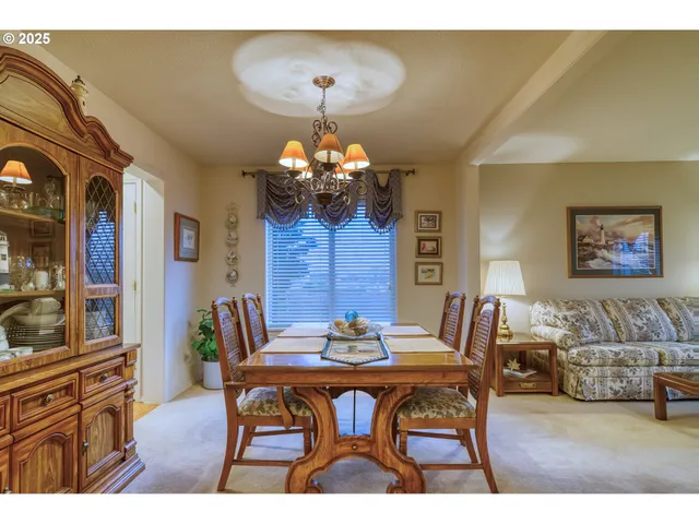a view of a dining room with furniture and chandelier