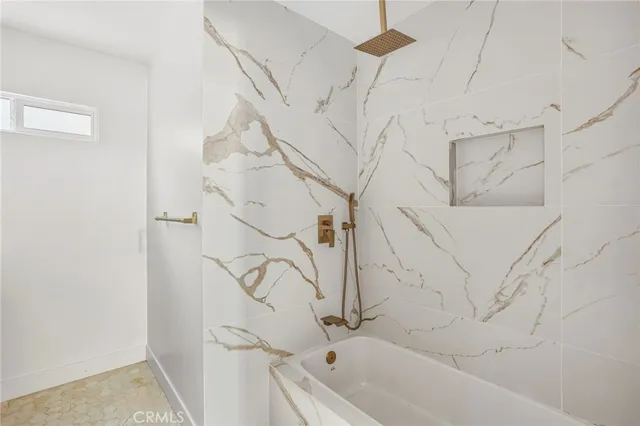 a bathroom with a bathtub and shower