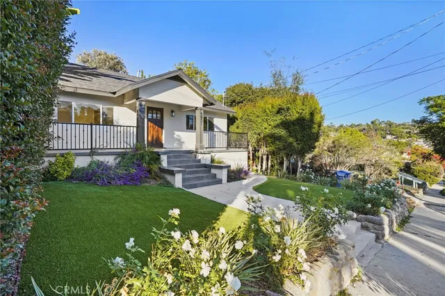 a front view of a house with garden