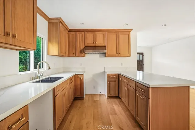 a kitchen with granite countertop a sink stove and cabinets