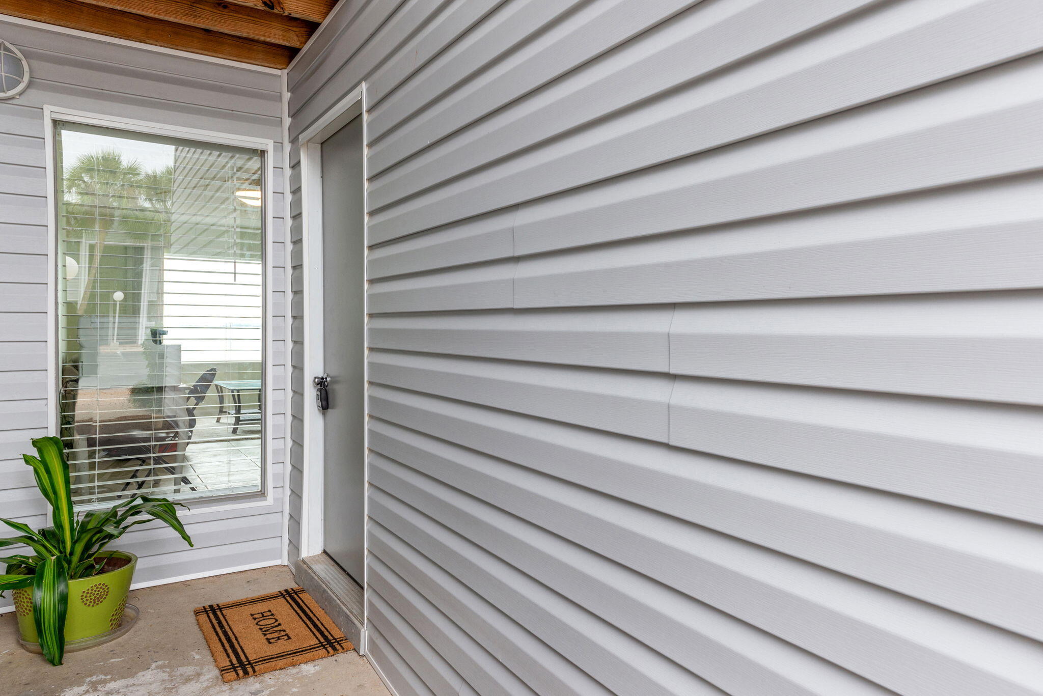 101 Old Ferry Road, Unit 23A Shalimar, FL 32579 - Photo 3 of 26 a view of a balcony with wooden floor and a potted plant