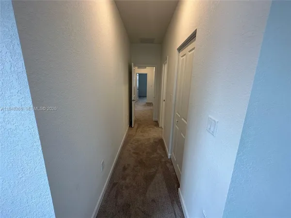 a view of a hallway with a wooden floor