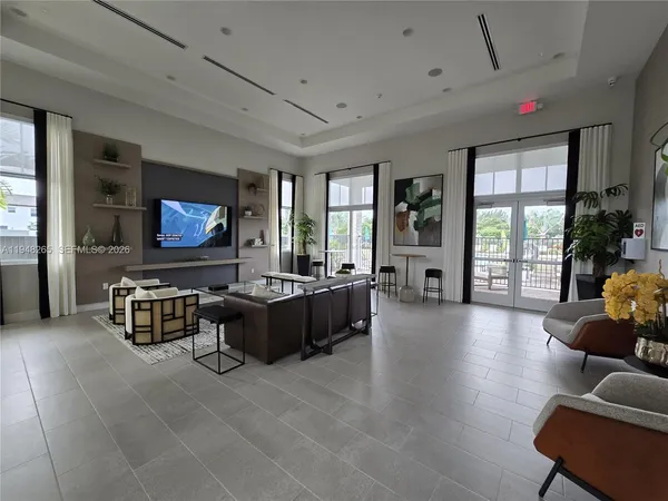 a living room with furniture wooden floor and a flat screen tv