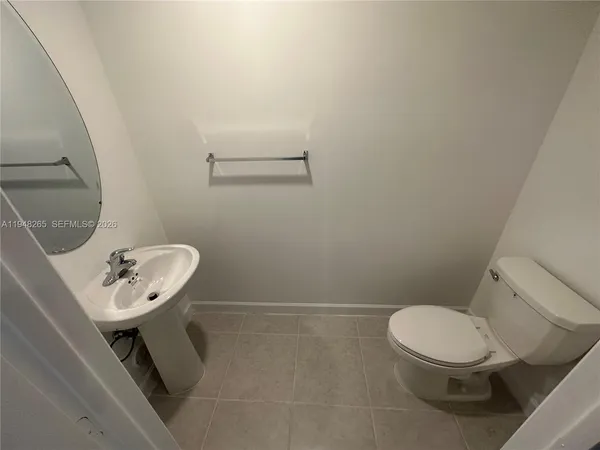 a white toilet sitting next to a bathroom sink