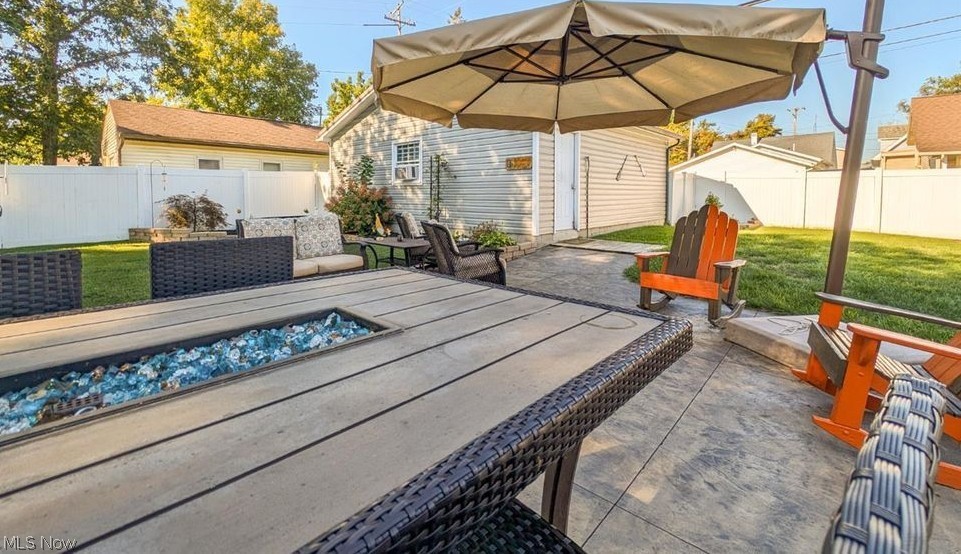41 Poplar Street Huron, OH 44839 - Photo 26 of 37 Deck with an outdoor fire pit, a patio, and a fenced backyard