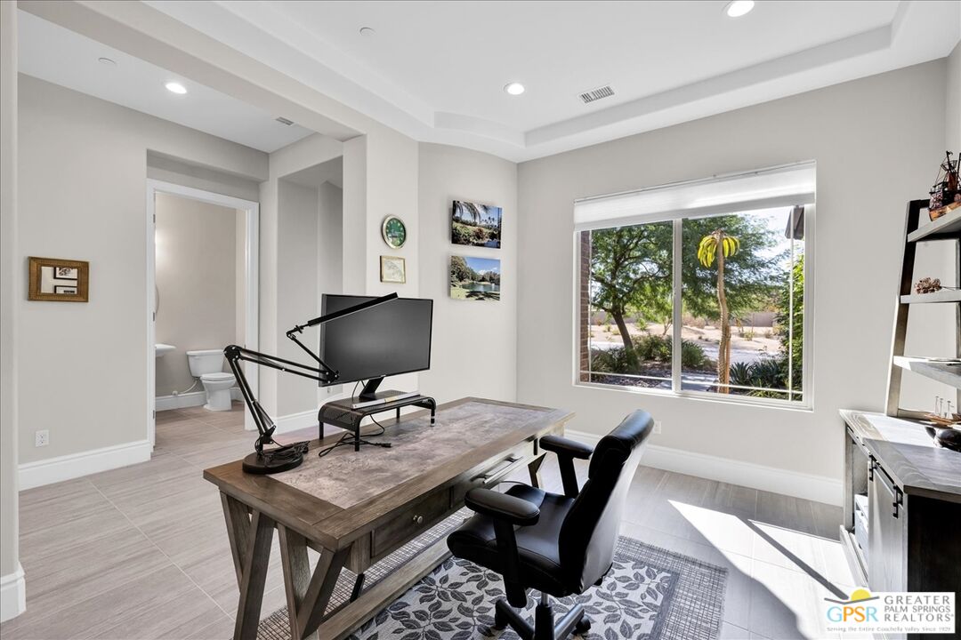 82 Cabernet Rancho Mirage, CA 92270 - Photo 14 of 25 a work room with furniture and a fireplace