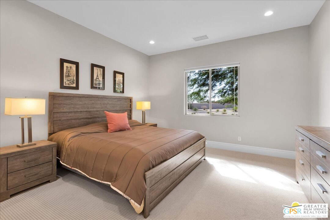 82 Cabernet Rancho Mirage, CA 92270 - Photo 16 of 25 a bedroom with a bed a lamp and a window