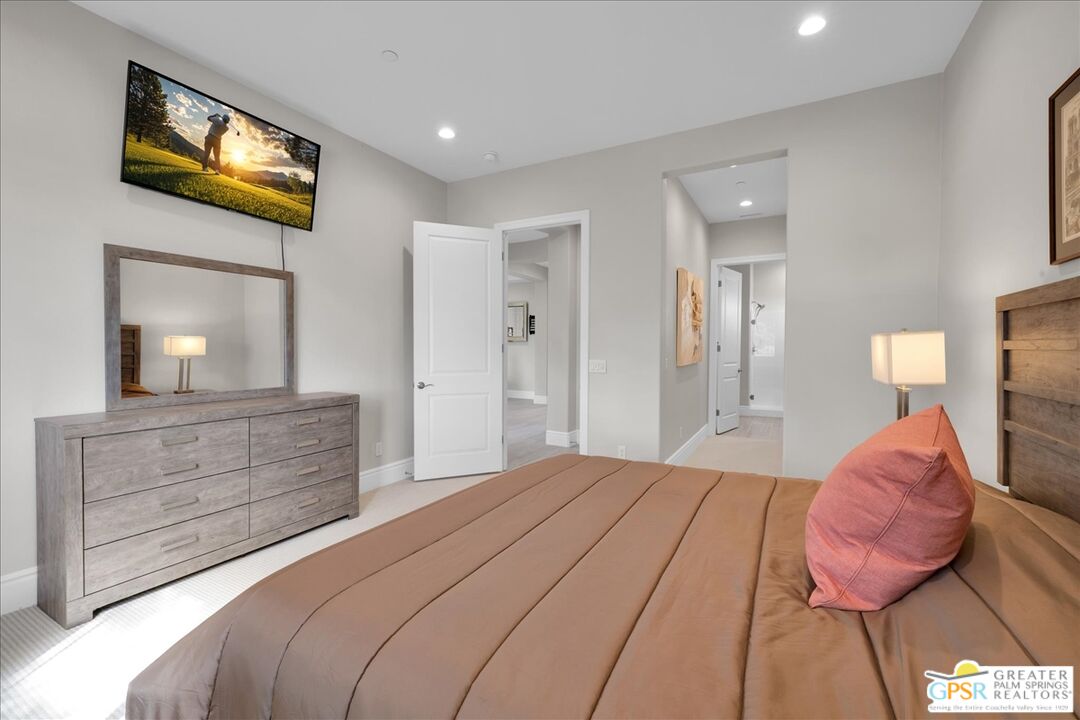 82 Cabernet Rancho Mirage, CA 92270 - Photo 17 of 25 a bedroom with a bed and a flat tv screen on dresser