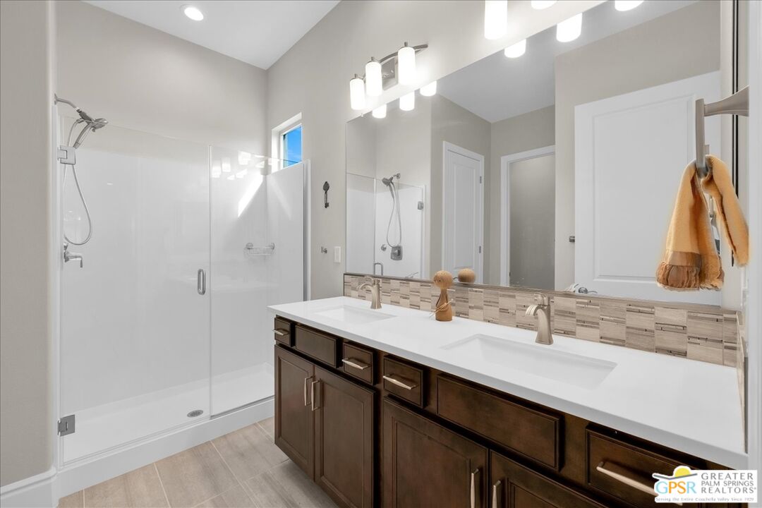 82 Cabernet Rancho Mirage, CA 92270 - Photo 18 of 25 a bathroom with a double vanity sink a mirror and a shower