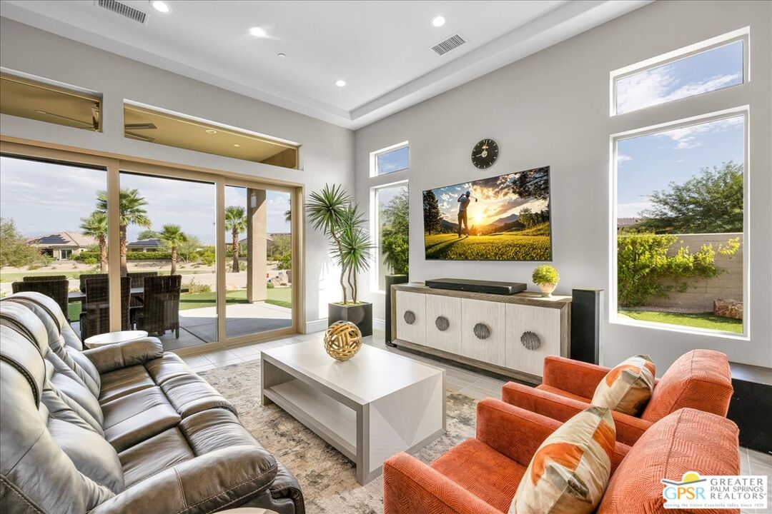 82 Cabernet Rancho Mirage, CA 92270 - Photo 2 of 25 a living room with furniture flat screen tv and a large window