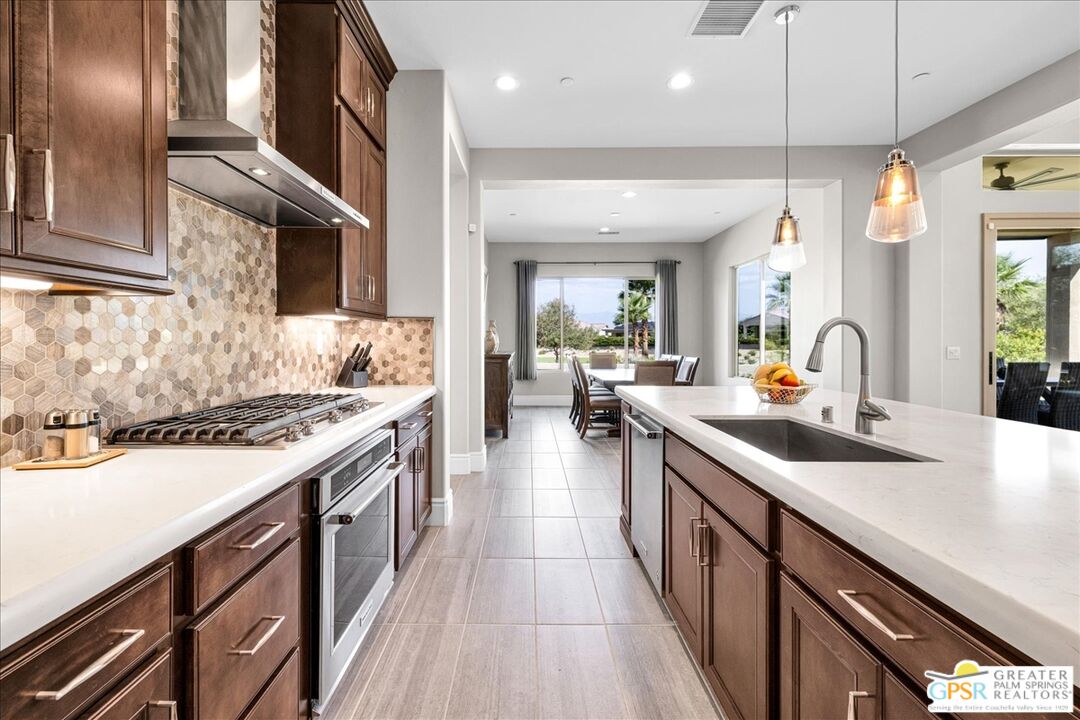 82 Cabernet Rancho Mirage, CA 92270 - Photo 3 of 25 a kitchen with stainless steel appliances a sink stove and cabinets