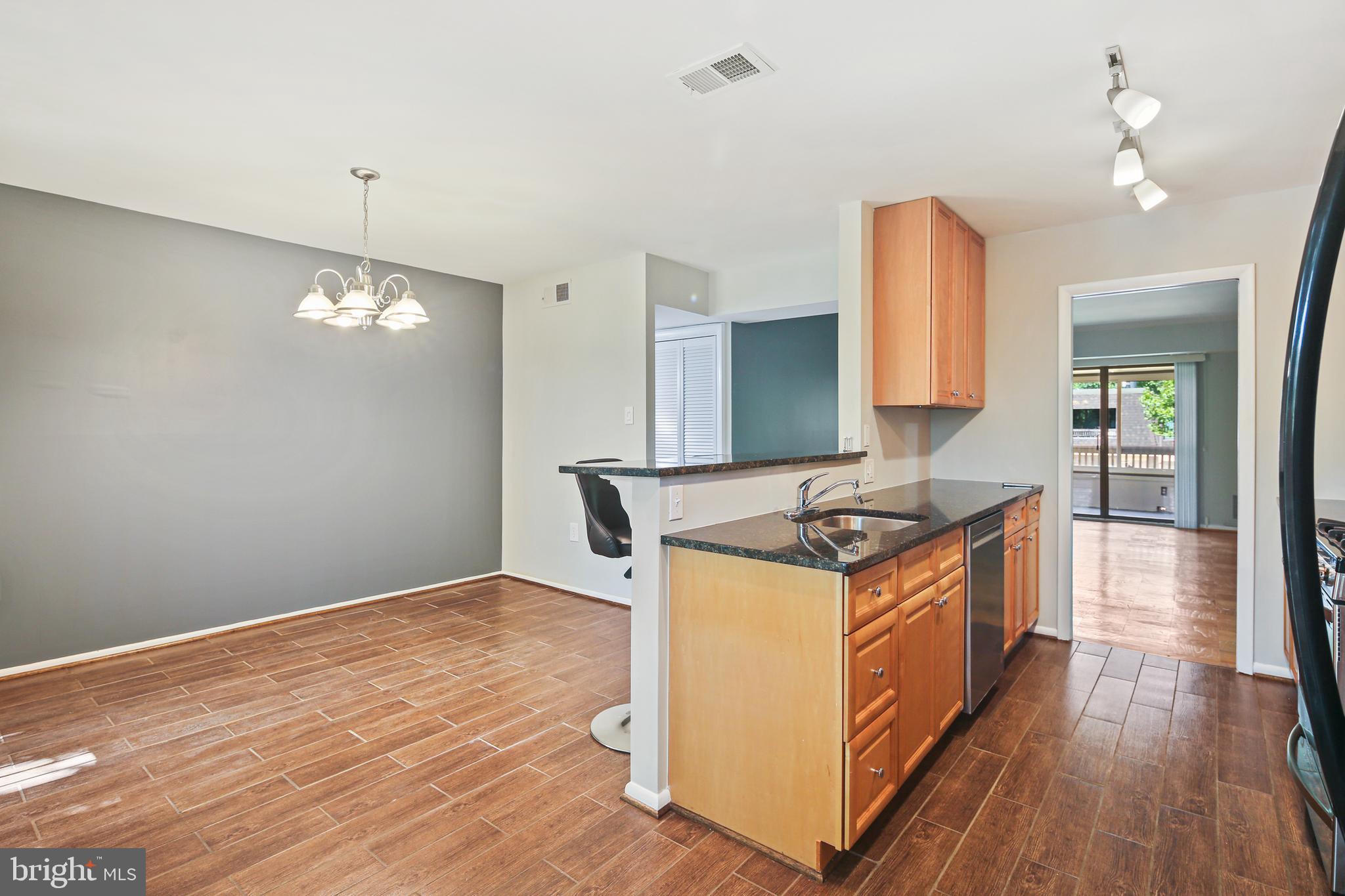 5239 West Running Brook Road, Unit 301 Columbia, MD 21044 - Photo 11 of 33 a kitchen with granite countertop a stove and a sink