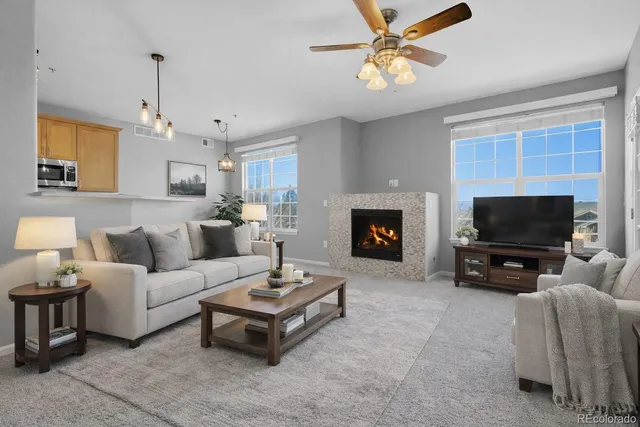 a living room with furniture a flat screen tv and a fireplace
