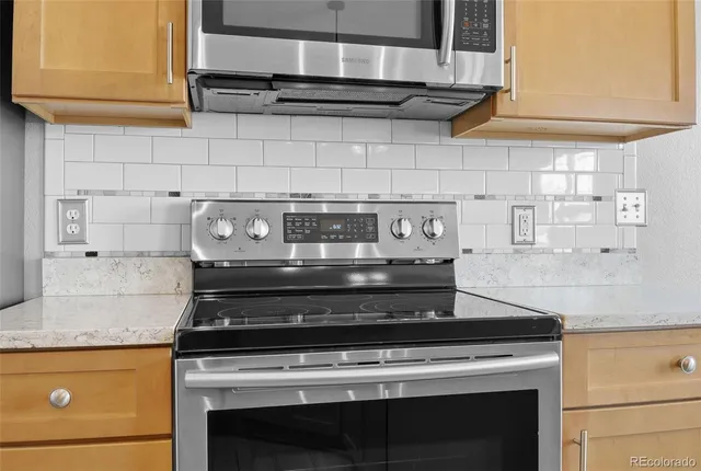 a stove top oven sitting inside of a kitchen