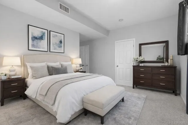 a bedroom with a bed and a dresser